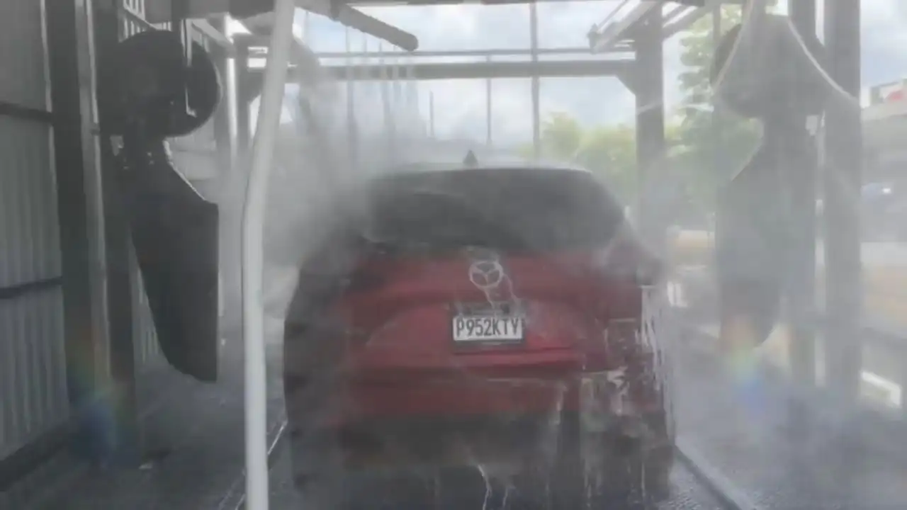 Vehicle moving through an automatic car wash