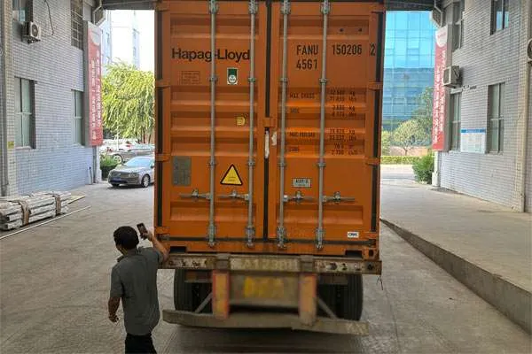 Container truck carrying a car wash machine shipment