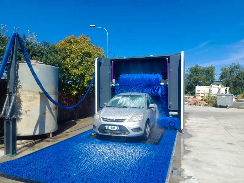 Rollover machine washing a vehicle at an installed customer site